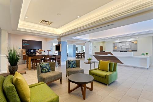 a living room with chairs and a table at Holiday Inn Express Hauppauge-Long Island, an IHG Hotel in Hauppauge