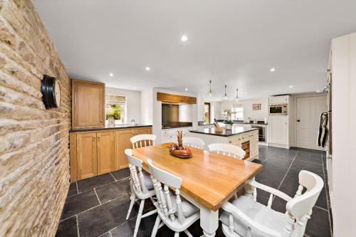 a kitchen and dining room with a wooden table and chairs at Chantry House in Barnsley