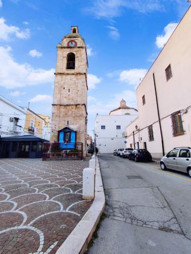 a clock tower in the middle of a street at Dimora della Marchesa - al Duomo in Manfredonia