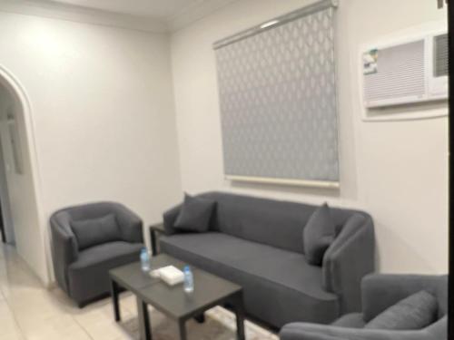 a living room with a couch and two chairs and a table at Smart Apartments - Yanbu in Yanbu