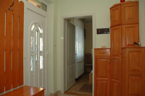 a room with a hallway with a door and a dresser at Zöldike Vendégház in Kaposvár