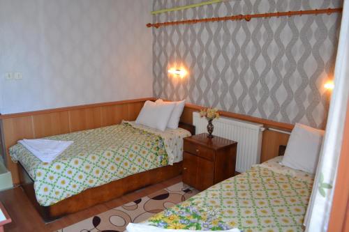 a small bedroom with two beds and a table at Aspawa Hotel in Pamukkale