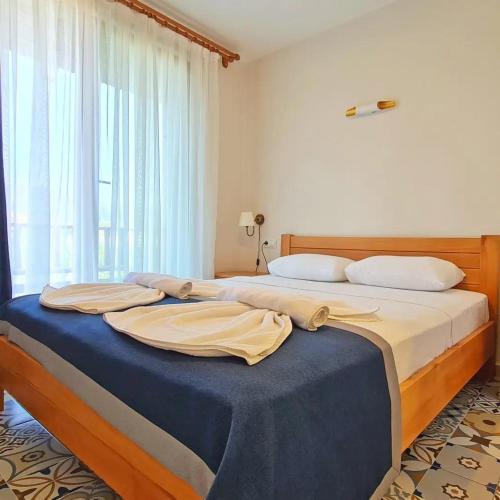 a bedroom with two beds and a large window at Akcapinar Korfez Butik Otel in Akyaka