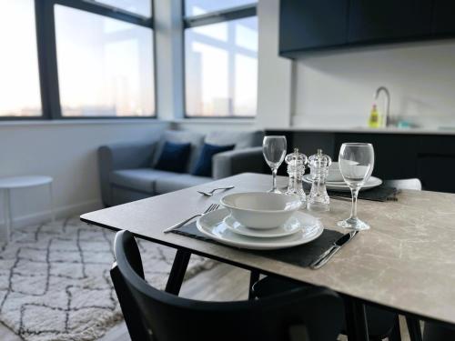 - une table avec un bol et des verres à vin dans l'établissement Fabulous one bedroom apartment near Old Trafford Stadium, à Manchester