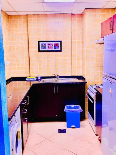 a kitchen with a sink and a dishwasher at Jin Jie Residence in Dubai