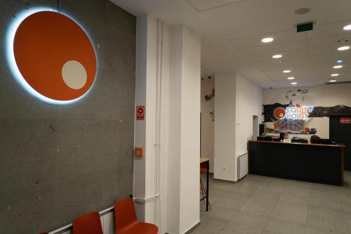 an office lobby with orange chairs and a counter at Equity Point Budapest in Budapest