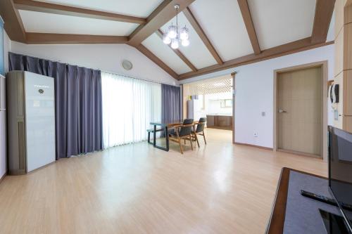 a large living room with a table and chairs at Clear morning pet friendly pension in Gyeongju