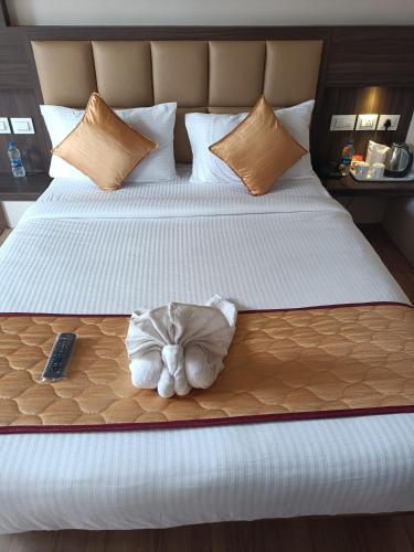 a hotel room with a bed with a towel on it at Golden Peaks Hotel & Restaurant in Kalimpong