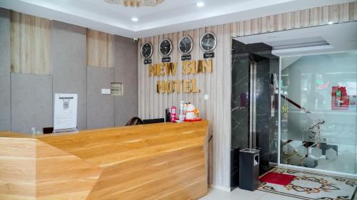 a new star hotel lobby with a wooden counter at New Sun Hotel Phu Nhuan in Ho Chi Minh City