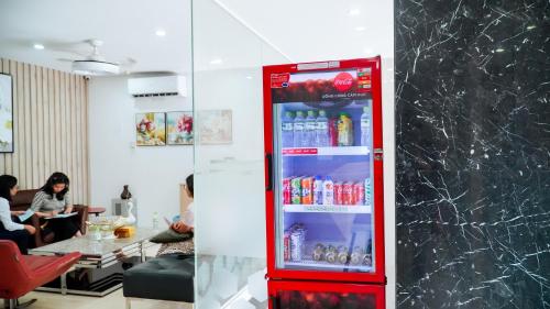 a red cocacola soda refrigerator in a restaurant at New Sun Hotel Phu Nhuan in Ho Chi Minh City
