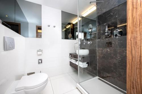 a bathroom with a toilet and a shower at Leonardo Boutique Hotel Krakow City Center in Krakow