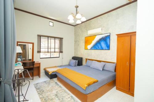 a bedroom with a bed and a desk in it at Loft Villa 1190 - Islamic Homestay in Malacca