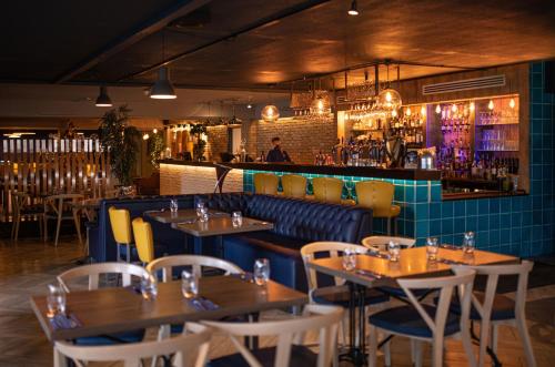 a restaurant with tables and chairs and a bar at Nox Hotel Galway in Galway