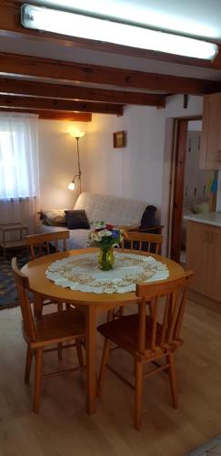 a room with a table and chairs and a bed at Agroturystyka Lisa Młyn in Najmowo