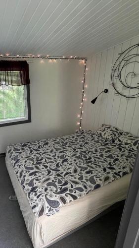 a bedroom with a bed with lights on it at Évika boutique hotel in Eskilsby