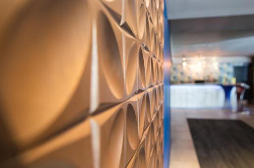 a wall with a bunch of wooden panels on it at Nox Hotel Galway in Galway
