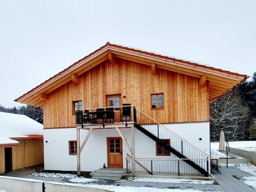a log home with a staircase on the side of it at Ferienwohnungen Koller in Bad Aibling