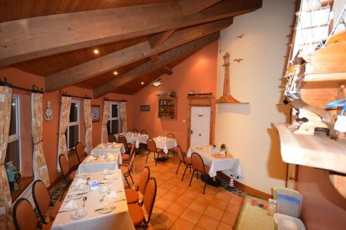 a restaurant with tables and chairs in a room at Crockatinney guest house in Ballintoy