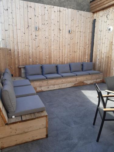 a couch in a room with a wooden wall at Het Helmgras in Middelkerke
