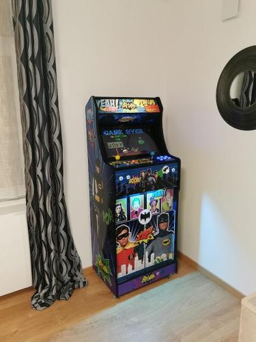 a video game machine sitting on the floor next to a wall at L'AisCal Appart-Hôtel 6 Personnes in Calais