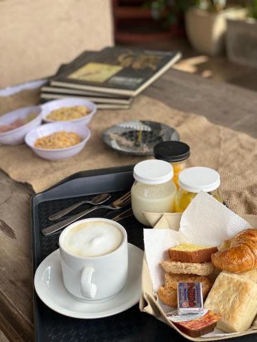 a tray of food with a cup of coffee and bread at Agrippina in Villa Carlos Paz