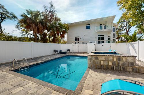 a swimming pool in front of a house at Tybee White Mansion in Tybee Island