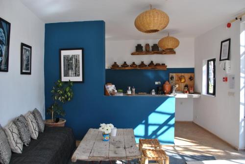 a living room with a couch and a table at Maison Sidi et Lalla in Essaouira