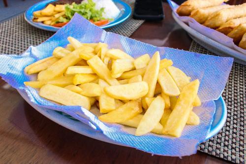 a bowl of french fries on a table at Hotel Pousada Mahon Mar in Praia do Frances