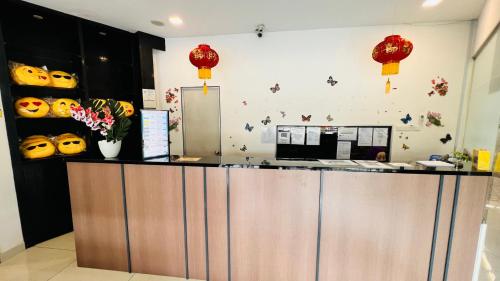 a restaurant with a counter with pumpkins on the wall at Seeds Hotel Cheras Taman Bukit Segar in Cheras