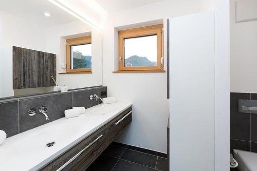 La salle de bains est pourvue d'un lavabo et d'un miroir. dans l'établissement Chalet am Breitenberg Appartement CB 12, à Pfronten