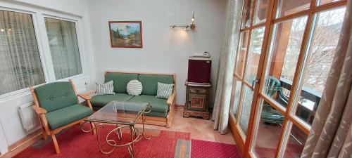 a living room with two chairs and a table at Hotel - Pension - Heidelberg inkl. Chiemgaukarte in Ruhpolding