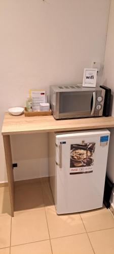 a counter with a microwave on top of a refrigerator at Apartmán neďaleko centra mesta in Michalovce