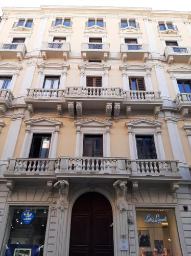 a building with a balcony on top of it at Umberto House Catania in Catania