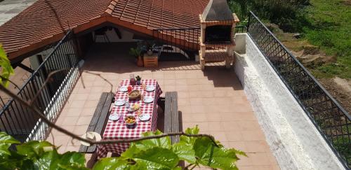 a table with plates of food on a patio at Casa Agrícola Do Limonete in Figueira da Foz