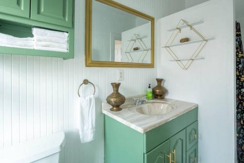 a bathroom with a sink and a mirror at Postmodern Penthouse 1 Min Walk Dining and Shops in Winooski