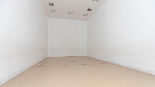 an empty room with white walls and a tile floor at Two-Bedroom Apartment in Orange Beach