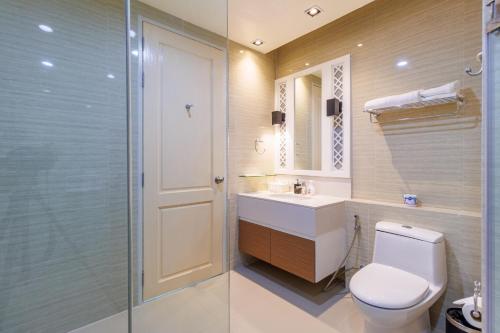 a bathroom with a toilet and a sink and a shower at Sea Sand Sun Hua Hin by JC Kevin Hotel & Resort in Phetchaburi