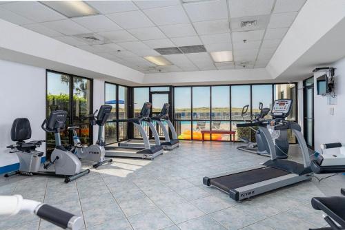 a gym with treadmills and elliptical machines at One-Bedroom Apartment in Orange Beach