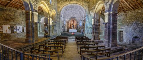 a church with a bunch of chairs in it at HOTEL RURAL OSCOS in Villanueva de Oscos