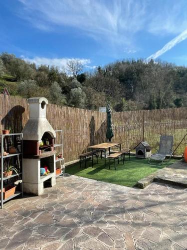 a backyard with a pizza oven and a picnic table at Al vecchio Mulino in Lastra a Signa