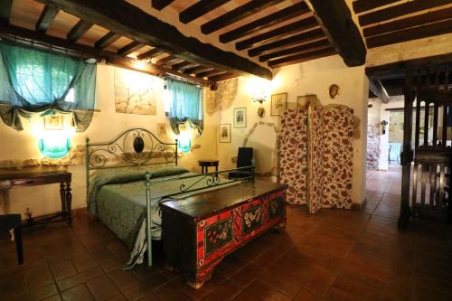1 dormitorio con 1 cama y 1 mesa en una habitación en La collina dei ciliegi, en Cagli
