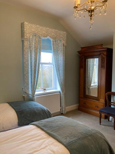 a bedroom with two beds and a window at The Old Lodge Guest House in Lincoln