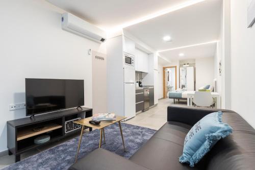 a living room with a couch and a tv at dobohomes - Puenteareas in Madrid