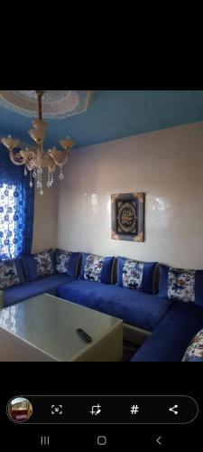 a living room with a blue couch and a table at A5 BELLA VISTA Cabo Negro Martil in Martil