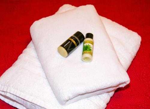 a white towel with a bottle of lipstick on it at Luxury Chez-Moi in Serres