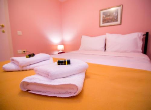 a hotel room with two beds with towels on them at Luxury Chez-Moi in Serres