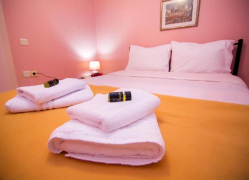 a bedroom with two beds and towels on a table at Luxury Chez-Moi in Serres