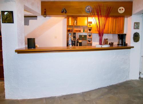a white bar with a wooden counter top at Luxury Chez-Moi in Serres