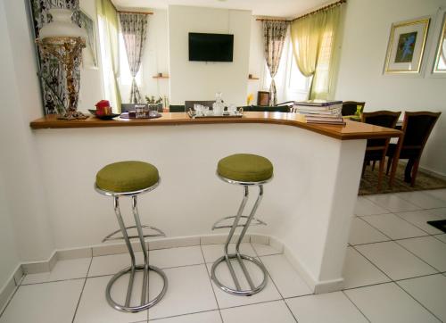 a kitchen with two stools sitting at a counter at Luxury Chez-Moi in Serres