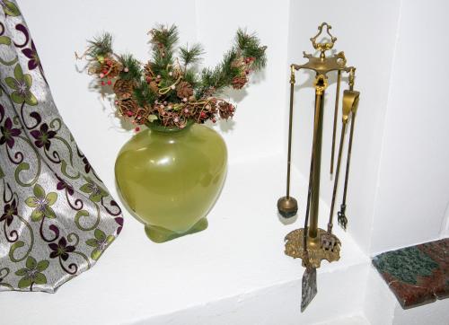 a green vase with flowers in it on a wall at Luxury Chez-Moi in Serres